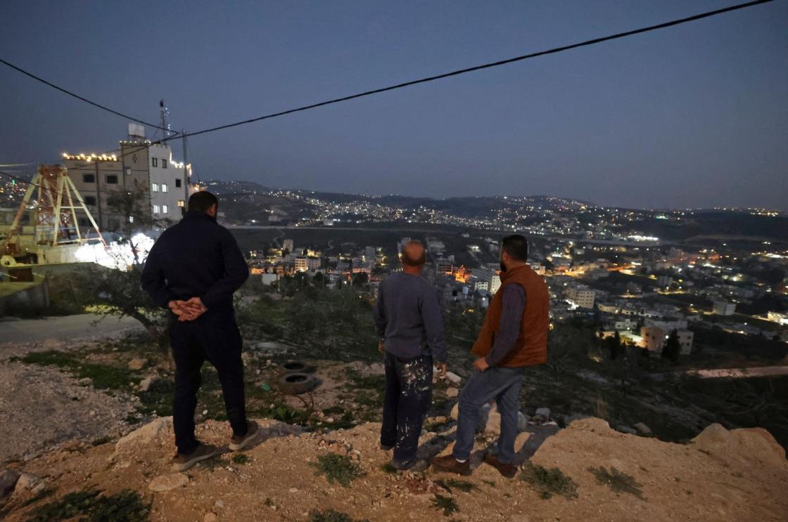 Palestinians stand guard in Huwara, in the occupied West Bank, Palestine, Feb. 28, 2023. (AFP Photo)