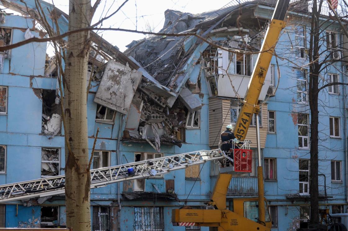 Ukrainian rescuers on an escalator work on a five-story residential building destroyed in a missile strike, Zaporizhzhia, Ukraine, March 2, 2023. (AFP Photo)