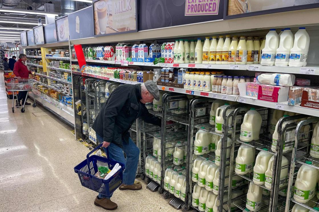 A customer shops for milk inside a supermarket in east London, U.K., Feb. 20, 2023. (AFP Photo)