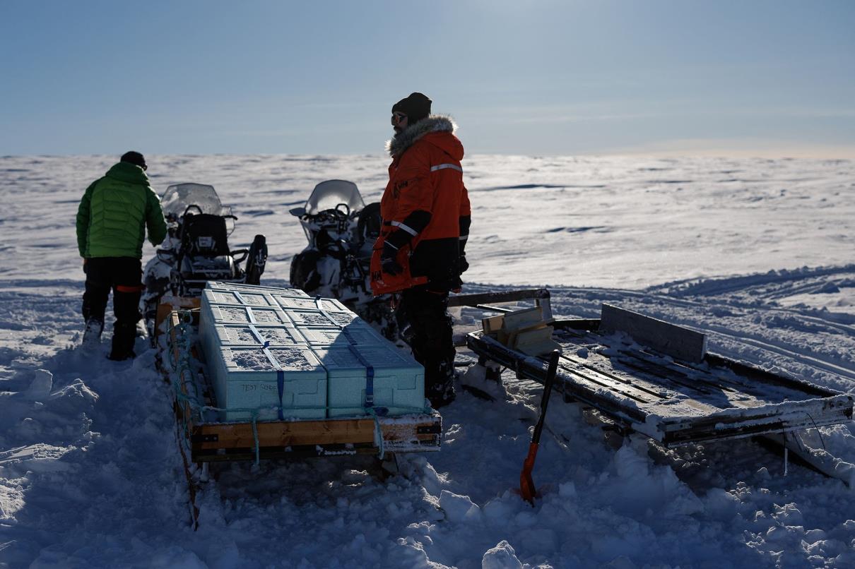 Glaciologists Jean-Charles Gallet (R), 41, and Federico Scoto ride motorbikes as they pull sleds loaded with boxes of ice cores waiting to be brought back for storage to Ny-Aalesund, Svalbard, Norway, April 10, 2023. (Reuters Photo)