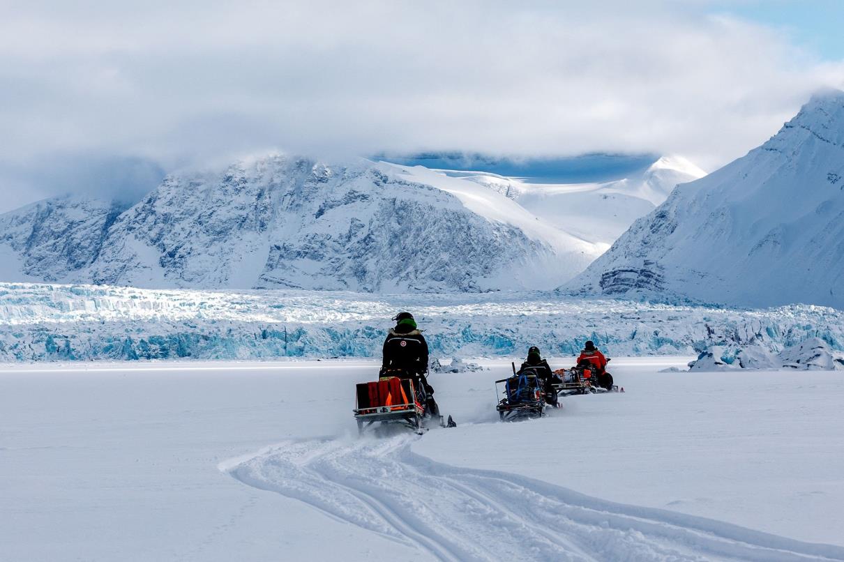 Scientists ride their snowmobiles near Kro<em></em>nebreen glacier through the arctic landscape near Ny-Alesund, Svalbard, Norway, April 10, 2023. (Reuters Photo)