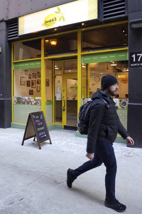 A pedestrian walks past Imee's Mediterranean Kitchen, a downtown Chicago restaurant, on Thursday, Feb. 2, 2023. 