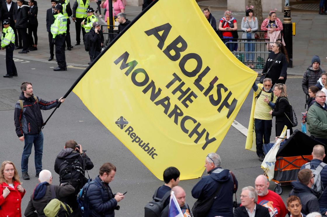 A protester holds a flag saying 