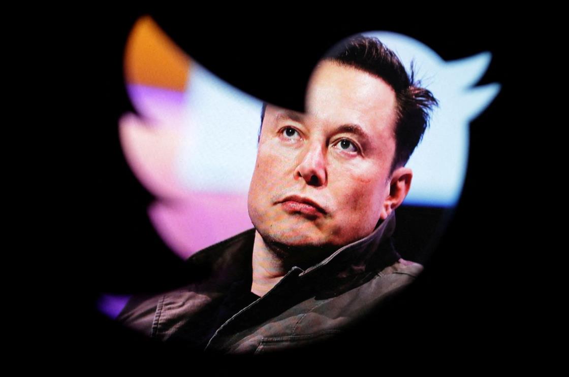 Elon Musk's photo is seen through a Twitter logo in this illustration dated Oct. 28, 2022. (Reuters Photo)