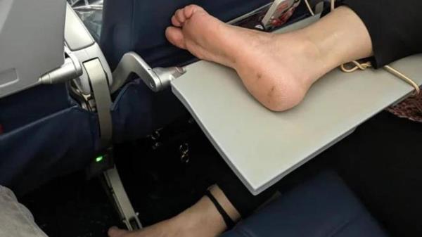 Barefeet on airplane. A picture taken by Luka, a passenger on a flight from Seattle to Orange County. Luka was shocked when he noticed the passenger next to him had put their bare feet on the tray table.