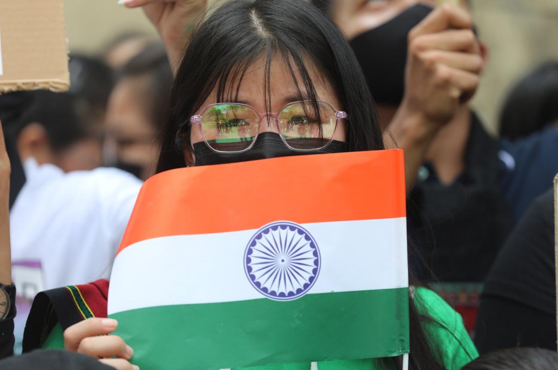 A woman holds the Indian flag, as members of the Kuki tribe take part in a tribal solidarity protest against the alleged ethnic cleansing in Manipur state, New Delhi, India, May 31, 2023. (EPA Photo)