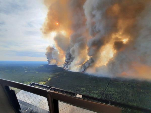 Smoke rises from a wildfire in the Do<em></em>nnie Creek area south of Fort Nelson.