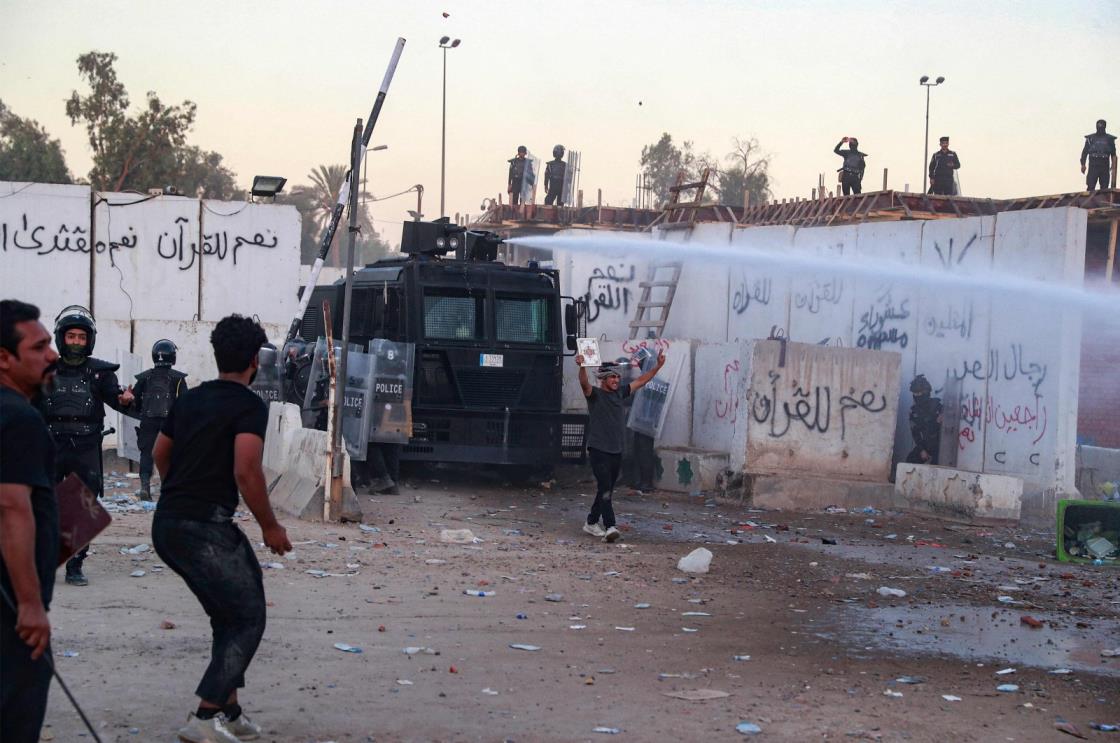 Iraqi riot police use water cannon to disperse protesters outside the Swedish embassy in Baghdad, Iraq, July 20, 2023. (AFP Photo)