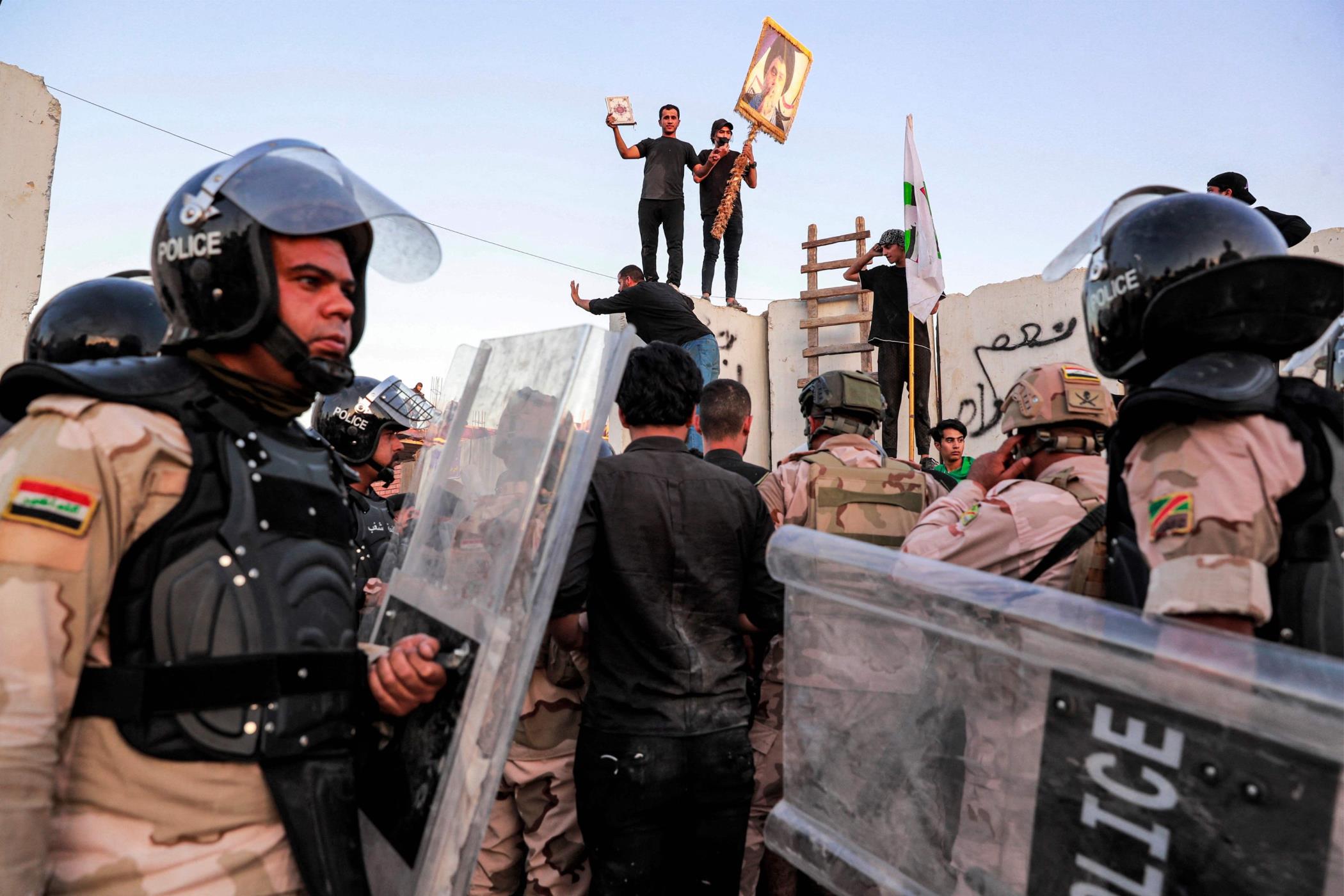 Iraqi riot police try to disperse protesters outside the Swedish embassy in Baghdad on July 20, 2023. (AFP Photo)