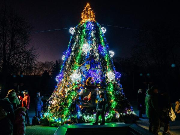 A Christmas tree made of camouflage nets draws a small crowd in Mykolaiv, on Dec. 19, 2022, amid the Russian invasion of Ukraine.